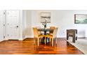 Modern dining area with dark wood table and neutral colored chairs at 3334 Peachtree Ne Rd # 704, Atlanta, GA 30326