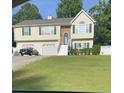 Two-story house with two-car garage and landscaped yard at 1620 Cedar Hl, Douglasville, GA 30134