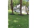 Two story house with white siding, gray roof, and landscaping at 4604 Shumart Dr, Snellville, GA 30039