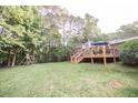 Large backyard with deck, trees, and playset at 377 Mill Ridge Way, Lawrenceville, GA 30046