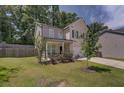 Two-story brick home with a front porch and yard at 2248 Annes Lake Cir, Lithonia, GA 30058
