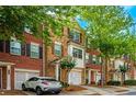 Brick townhouses with attached garages and lush landscaping at 2100 Meadow Peak Rd, Duluth, GA 30097
