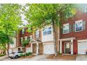 Brick townhouse with two-car garage and landscaping at 2100 Meadow Peak Rd, Duluth, GA 30097