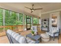 Spacious screened porch with comfortable seating and a ceiling fan at 105 Summerlin Dr, Canton, GA 30115
