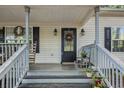 Inviting front porch with rocking chairs and wreath at 104 Streambank Ct, Temple, GA 30179