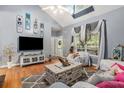 Living room with vaulted ceilings, hardwood floors, and large windows at 104 Streambank Ct, Temple, GA 30179