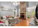 Living room features a stone fireplace and hardwood floors at 104 Streambank Ct, Temple, GA 30179