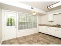 Kitchen with white cabinets, granite countertops, and tile floor at 4245 Brandy Ann Dr, Acworth, GA 30101