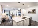 Open concept kitchen with island, stainless steel appliances, and a view of the living room at 3351 Orwell Way # 2104, Cumming, GA 30041