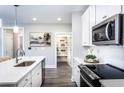 Modern kitchen with white cabinets, stainless steel appliances, and a walk-in pantry at 3351 Orwell Way # 2104, Cumming, GA 30041