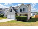 Two-story house with gray siding, two-car garage, and manicured lawn at 5908 Bluegrass Vw, Fairburn, GA 30213