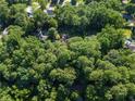 House surrounded by lush green trees at 4872 Northland Dr, Atlanta, GA 30342