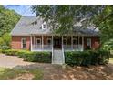 Brick home with a large wrap-around porch at 3651 Chandler Haulk Rd, Loganville, GA 30052