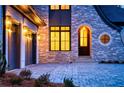 Luxury home with stone accents and three-car garage at dusk at 4215 Tattnall Run, Acworth, GA 30101