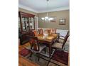 Formal dining room with hardwood floors, chandelier and china cabinet at 9904 Hamilton Dr, Douglasville, GA 30135