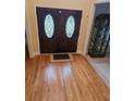 Hardwood floors and double doors with glass accents in the entryway at 9904 Hamilton Dr, Douglasville, GA 30135