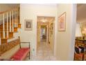 Bright entry hall with tiled floor, bench, and staircase at 3081 Howell Mill Nw Rd # 3, Atlanta, GA 30327