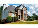 Two-story brick home with lush landscaping at 75 Northwood Springs Dr, Oxford, GA 30054