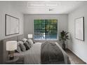 Virtually staged bedroom with large window and treetop views at 2110 Glenwood Downs Dr, Decatur, GA 30035