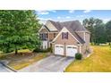 Two-story house with a large front yard and two-car garage at 3037 Nicholas Dr, Villa Rica, GA 30180