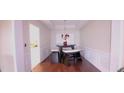 Dining area with hardwood floors and a charming chandelier at 5179 Meadowbrooke Chase, Stone Mountain, GA 30088