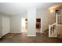 Living room with wood-look floors and access to kitchen and stairs at 2086 Teal Cv, Lithonia, GA 30058