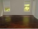 Bedroom featuring dark hardwood floors and two windows with blinds at 6571 Splitpine Ct, Atlanta, GA 30349