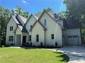 Two-story white brick home with gray accents, landscaping, and a two-car garage at 270 Crosstree Ln, Atlanta, GA 30328