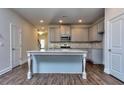 Modern kitchen with gray cabinets, granite countertops, and a large island at 6124 Ripple Way # 45, South Fulton, GA 30349