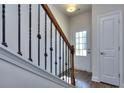 Bright entryway with hardwood floors, an interior door, and a wooden staircase at 6104 Ripple Way # 50, South Fulton, GA 30349