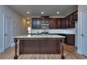 Kitchen with island, granite countertops, and dark cabinets at 6116 Ripple Way # 47, South Fulton, GA 30349