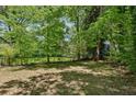 Large grassy backyard surrounded by lush trees, providing ample privacy at 1886 S Gordon Sw St, Atlanta, GA 30310