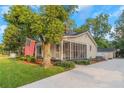 Yellow house with a front porch, screened porch and driveway at 1068 N Main Nw St, Conyers, GA 30012