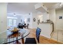 Bright dining area with hardwood floors, a glass-top table and kitchen views at 955 Juniper Ne St # 4027, Atlanta, GA 30309