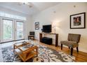 Bright living room with hardwood floors, comfy seating, and access to a private patio at 955 Juniper Ne St # 4027, Atlanta, GA 30309