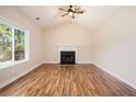 Living room with hardwood floors, fireplace, and vaulted ceiling at 20 Liberty Xing Ne Dr, Cartersville, GA 30121