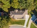 Aerial view of a house nestled in a wooded neighborhood at 971 Heathchase Dr, Suwanee, GA 30024