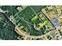 Aerial lot view showing property lines, several houses, and surrounding trees at 3525 Hamilton Mill Rd, Buford, GA 30519