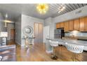 Open concept kitchen with granite countertop, light wood cabinets, and breakfast bar at 620 Glen Iris Ne Dr # 205, Atlanta, GA 30308