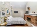 Spacious bedroom with brick fireplace and hardwood floors at 604 Glen Iris Ne Dr, Atlanta, GA 30308