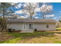 Rear view of a light beige house with a patio and yard at 105 Adrian Dr, Stockbridge, GA 30281