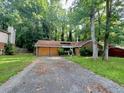 Home exterior with damaged siding and overgrown lawn at 445 Independence Dr, Jonesboro, GA 30238