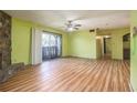 Spacious living room with wood-look floors, fireplace and access to balcony at 112 Camelot Dr, Atlanta, GA 30349
