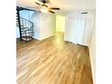 Spacious living room with wood-look floors and spiral staircase at 4701 Flat Shoals Rd # 68D, Union City, GA 30291