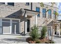 Brick front exterior of townhome with attached garage and landscaping at 108 Matson Sw Run, Mableton, GA 30126