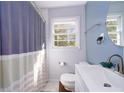 Updated bathroom with a white vanity and blue shower curtain at 2785 Toney Dr, Decatur, GA 30032