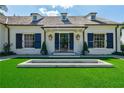 Stunning white home with blue shutters and manicured lawn at 2880 Bakers Farm Se Rd, Atlanta, GA 30339