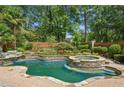 Inviting pool and spa with flagstone decking at 1270 Star Ne Dr, Brookhaven, GA 30319