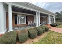 Brick house with a large front porch and columns at 3355 Smithtown Rd, Suwanee, GA 30024