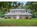 Two-story house with brick and siding, featuring a manicured lawn at 5187 Vivid Dr, Stone Mountain, GA 30087